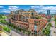 Low aerial shot of the entire building with balconies, roof decks and mature landscaping at 1499 Blake St # 4F, Denver, CO 80202