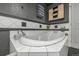 Bathroom featuring soaking tub with modern fixtures and decorative tile, creating a spa-like atmosphere at 1499 Blake St # 4F, Denver, CO 80202