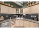 Modern kitchen with stainless appliances, black backsplash, and bright wooden cabinets at 1499 Blake St # 4F, Denver, CO 80202