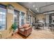 Living area with a brown chair and multiple doors leading to the outdoor patio at 1499 Blake St # 4F, Denver, CO 80202