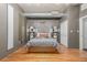 Main bedroom with hardwood floors, modern decor, and a comfortable bed at 1499 Blake St # 4F, Denver, CO 80202