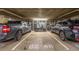 Well-lit parking garage with vehicles and storage cages provides secure parking at 1499 Blake St # 4F, Denver, CO 80202