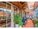 Inviting patio with chairs, hanging plants, and brick walls for a cozy outdoor space at 1499 Blake St # 4F, Denver, CO 80202