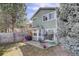 Backyard view of home with patio, lawn, and privacy fence at 8254 S Gaylord Cir, Centennial, CO 80122