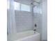 Bathroom features shower and tub with white tile surround at 8254 S Gaylord Cir, Centennial, CO 80122