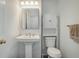 Updated bathroom features a pedestal sink and matching cabinet at 8254 S Gaylord Cir, Centennial, CO 80122