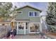 Back exterior of a two-story home with a patio and outdoor furniture at 8254 S Gaylord Cir, Centennial, CO 80122