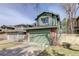 Inviting green exterior showcasing a two-story home with an attached two-car garage and brick accents at 8254 S Gaylord Cir, Centennial, CO 80122