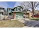 Inviting green exterior showcasing a two-story home with an attached two-car garage and brick accents at 8254 S Gaylord Cir, Centennial, CO 80122