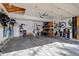 Spacious garage with ample storage solutions, including shelving and wall-mounted racks at 8254 S Gaylord Cir, Centennial, CO 80122