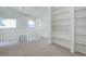 Upstairs loft features neutral carpet and custom built-in shelves with a ceiling fan at 8254 S Gaylord Cir, Centennial, CO 80122