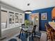 Dining room with a glass table and chairs with an adjacent view to the snowy backyard at 6700 W 11Th Ave # 103, Lakewood, CO 80214