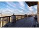Wide angle daytime shot of the expansive balcony with its wooden furniture and views of the valley at 11730 Pointe View Dr, Longmont, CO 80503