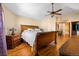 Bedroom with hardwood floors, ceiling fan, lamps, and views through the window at 11730 Pointe View Dr, Longmont, CO 80503