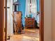 View into a bedroom, showcasing wooden floors, a window and a dresser at 11730 Pointe View Dr, Longmont, CO 80503