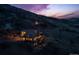 Beautifully lit home at twilight, showcasing its scenic location and spacious outdoor areas at 11730 Pointe View Dr, Longmont, CO 80503