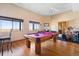 Large game room featuring a pool table, drum set, and hardwood flooring at 11730 Pointe View Dr, Longmont, CO 80503