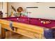 Close up of a pool table and drum set with hardwood flooring in the game room at 11730 Pointe View Dr, Longmont, CO 80503