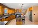 Open eat-in kitchen with stainless appliances, granite countertops, and fireplace in connected living space at 11730 Pointe View Dr, Longmont, CO 80503