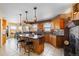 Spacious kitchen with large island, granite countertops, backsplash, tile floors, and stainless steel appliances at 11730 Pointe View Dr, Longmont, CO 80503