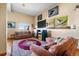 Relaxing living room with exposed beams, recessed lighting, hardwood floors, and mounted television at 11730 Pointe View Dr, Longmont, CO 80503