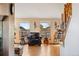 Bright living room features hardwood floors, many windows, comfortable seating, and access to stairs at 11730 Pointe View Dr, Longmont, CO 80503