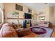 Comfortable living room with a fireplace, mounted TV, hardwood floors, and multiple seating options at 11730 Pointe View Dr, Longmont, CO 80503