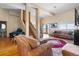 Open concept living area with high ceilings, hardwood floors, exposed beams, and patio access at 11730 Pointe View Dr, Longmont, CO 80503