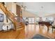 Bright, open concept living area with hardwood floors, wooden staircase, and vaulted ceilings at 11730 Pointe View Dr, Longmont, CO 80503