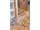 Close-up of tiled shower floor with accent pebbles at 11730 Pointe View Dr, Longmont, CO 80503