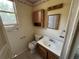 Cozy bathroom featuring wooden vanity, matching mirror, and a vintage light fixture at 10630 W 46Th Ave, Wheat Ridge, CO 80033