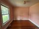 Bedroom with hardwood floors, one window, and a light fixture at 10630 W 46Th Ave, Wheat Ridge, CO 80033