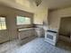 Kitchen with white cabinets, patterned tile floor, white appliances, and a window above sink at 10630 W 46Th Ave, Wheat Ridge, CO 80033