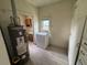 Functional laundry room with washer, water heater, and built-in storage at 10630 W 46Th Ave, Wheat Ridge, CO 80033