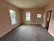 Living room with carpet, windows, and access to entry and other rooms at 10630 W 46Th Ave, Wheat Ridge, CO 80033
