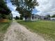 View of house and driveway, with mature landscaping and a neighboring house at 10630 W 46Th Ave, Wheat Ridge, CO 80033