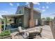 Exterior view of the backyard showing the covered patio, back deck, chimney, siding, and landscaped backyard at 7724 S Lafayette Ct, Centennial, CO 80122