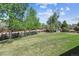 Wide-open backyard with manicured lawn and mature trees provides a peaceful and private outdoor setting at 7724 S Lafayette Ct, Centennial, CO 80122