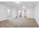 Basement area with neutral carpet, white walls, and an open doorway at 7724 S Lafayette Ct, Centennial, CO 80122