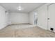 Spacious basement area with neutral carpet, white walls, and an open doorway at 7724 S Lafayette Ct, Centennial, CO 80122
