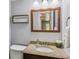Bathroom featuring decorative mirror, granite countertop, and stylish fixtures at 7724 S Lafayette Ct, Centennial, CO 80122