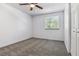 Simple bedroom with a window, neutral carpet, white walls, and closet at 7724 S Lafayette Ct, Centennial, CO 80122