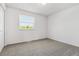 Bright bedroom features neutral carpet, white walls, and a window with natural light at 7724 S Lafayette Ct, Centennial, CO 80122