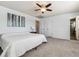 Bright bedroom featuring a large bed, neutral colors, and an ensuite bathroom at 7724 S Lafayette Ct, Centennial, CO 80122