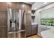 Modern kitchen with stainless steel refrigerator, wine rack, and quartz countertops at 7724 S Lafayette Ct, Centennial, CO 80122