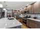 Spacious kitchen features an island, stainless appliances, ample cabinet space, and hardwood floors at 7724 S Lafayette Ct, Centennial, CO 80122
