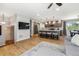 Open concept living room and kitchen with island seating, hardwood floors, and modern lighting at 7724 S Lafayette Ct, Centennial, CO 80122