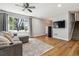 Bright living room features hardwood flooring, a neutral color palette, and a large window at 7724 S Lafayette Ct, Centennial, CO 80122