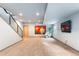 Spacious carpeted basement featuring a staircase, recessed lighting, and stylish modern decor at 5 Harrison St, Denver, CO 80206