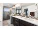 Modern bathroom featuring a double vanity, sleek countertops, and a glass-enclosed shower at 5 Harrison St, Denver, CO 80206